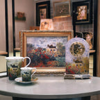 Decorative items including a framed painting, clock, and teacup set on a table.