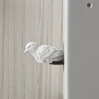 White ceramic dove sculpture on a wooden surface