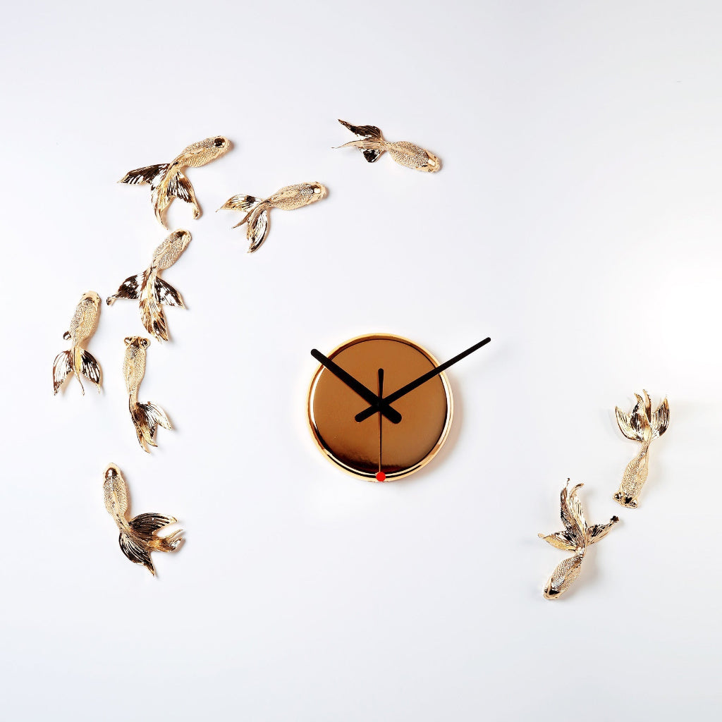Decorative wall clock with gold bird figurines on a white background available at Spacio retail stores in Mumbaii & Kolkata and online.