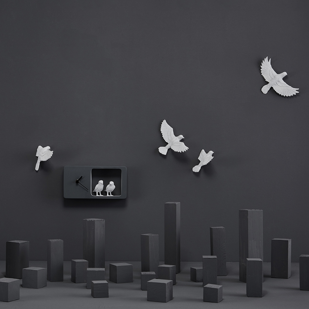 Haoshi Sparrow Clock in Dark Gray color on a dark grey wall with small grey boxes available at Spacio india for modern and luxury interiors from our Timepieces and clocks collection.