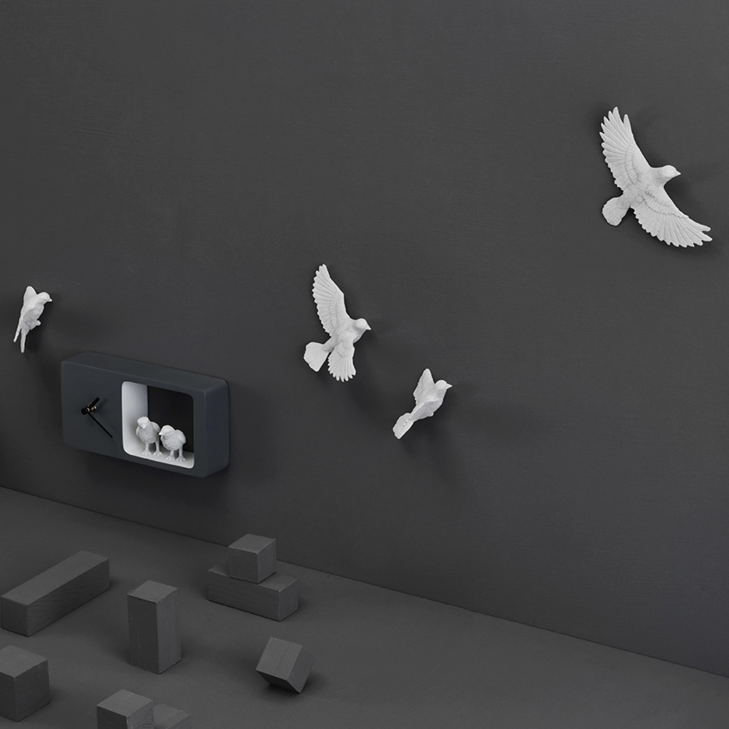 Tilted angle of Haoshi Sparrow Clock in Dark Gray color on a dark grey wall with small grey boxes available at Spacio india for modern and luxury interiors from our Timepieces and clocks collection.