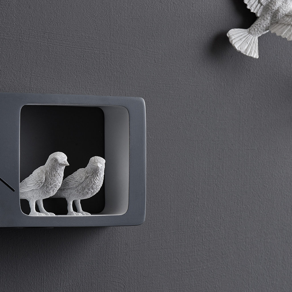Closer look of Haoshi Sparrow Clock in Dark Gray color on a dark grey wall with small grey boxes available at Spacio india for modern and luxury interiors from our Timepieces and clocks collection.