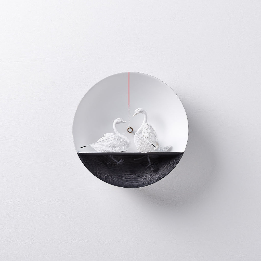 A Clock Haoshi Swan 02 by Haoshi, with two swans representing love. available at Spacio retail stores in Mumbaii & Kolkata and online.