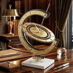 Decorative sundial design table clock on a wooden desk with books and a lamp in the background
