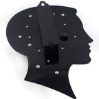 Black silhouette of a woman's head with decorative elements on a white background