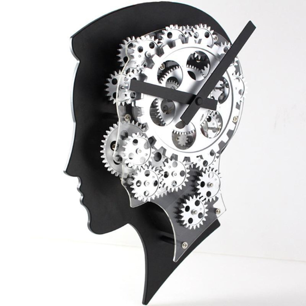 Wall clock designed like a human head with gears inside on a white background