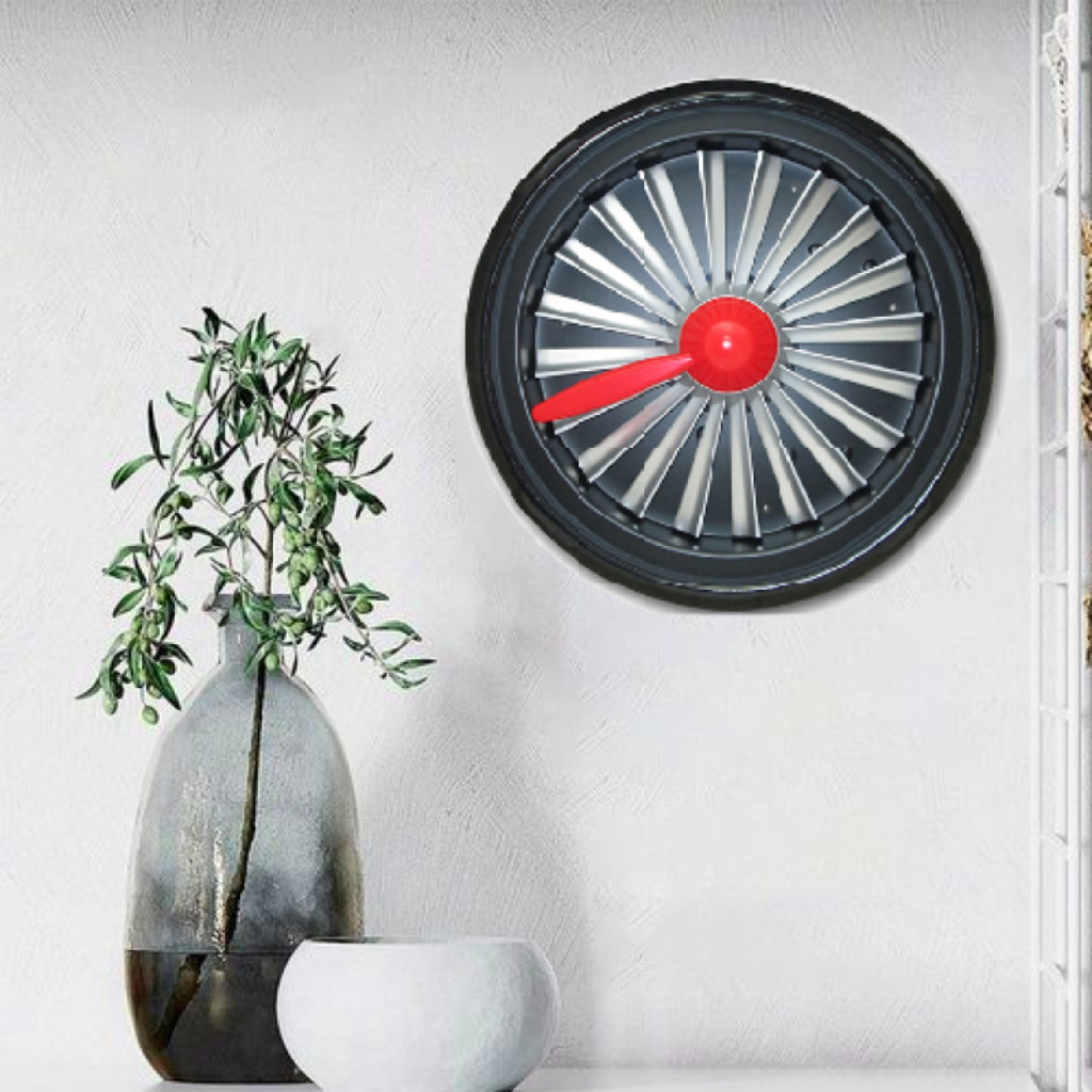 Modern wall clock with red秒针 on a white wall, next to a vase with greenery.