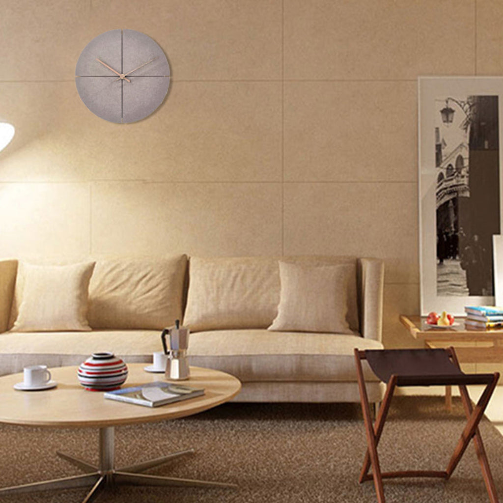 Modern living room with beige sofa, wooden coffee table, and wall clock.
