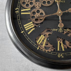 Close-up of a mechanical watch with intricate gears and gold accents on a gray background
