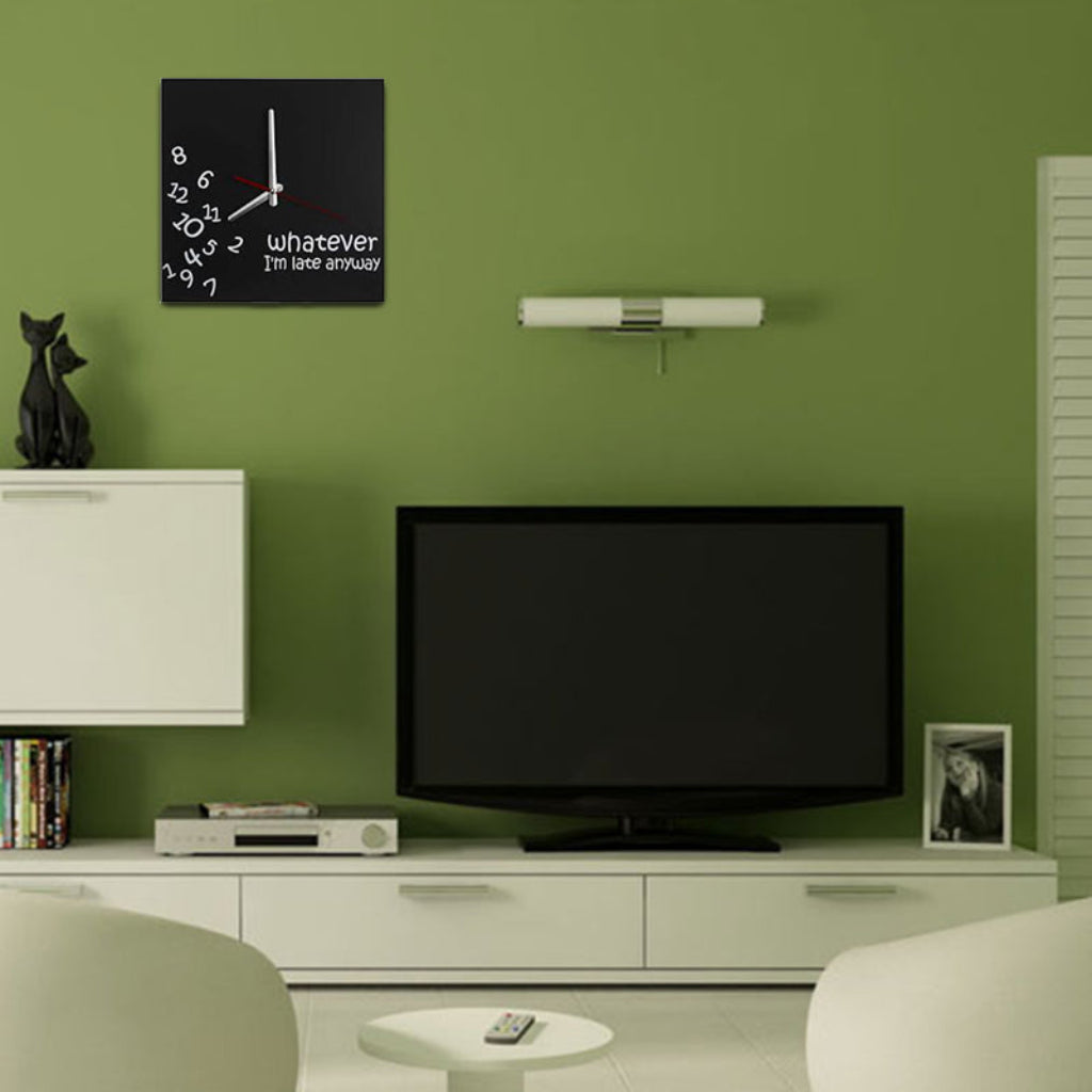 Living room with a television, white cabinet, and decorative items on a green wall.