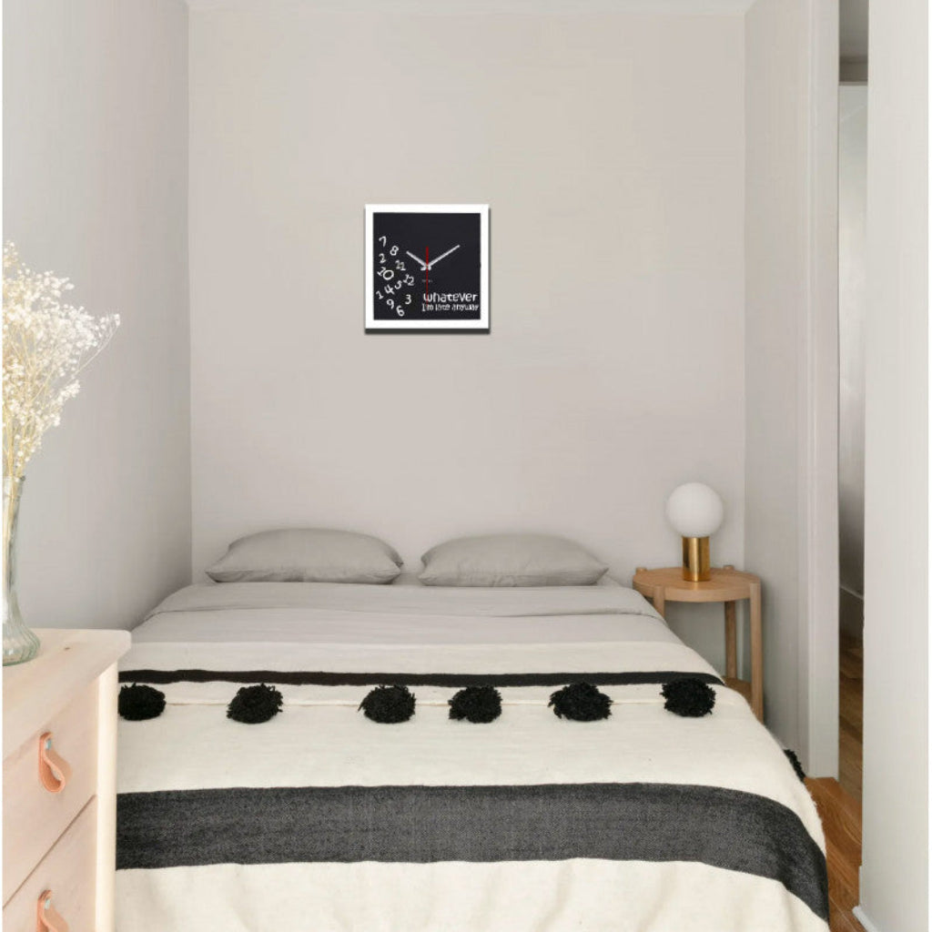 Bedroom with a bed, nightstands, and a wall clock.