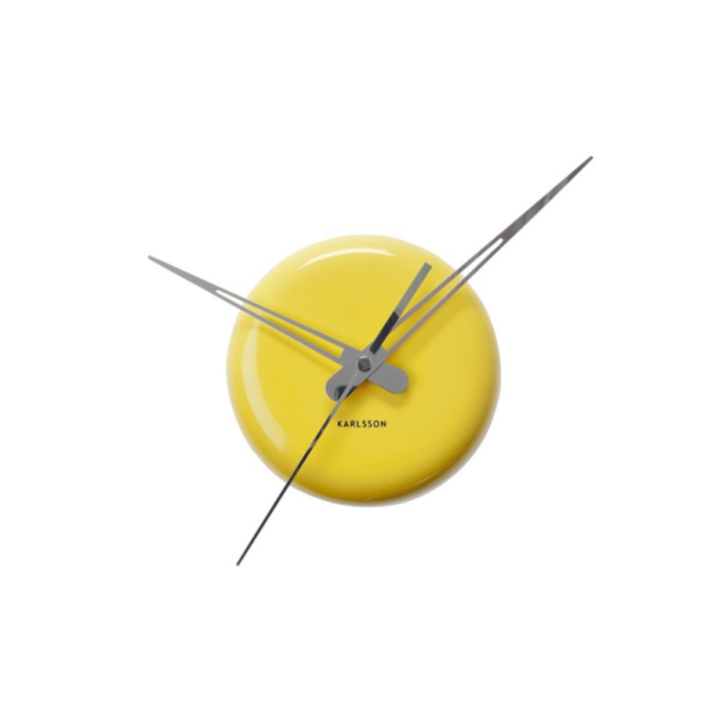Yellow wall clock with silver hands on a white background from Karlsson available at Spacio retail stores in Mumbaii & Kolkata and online.