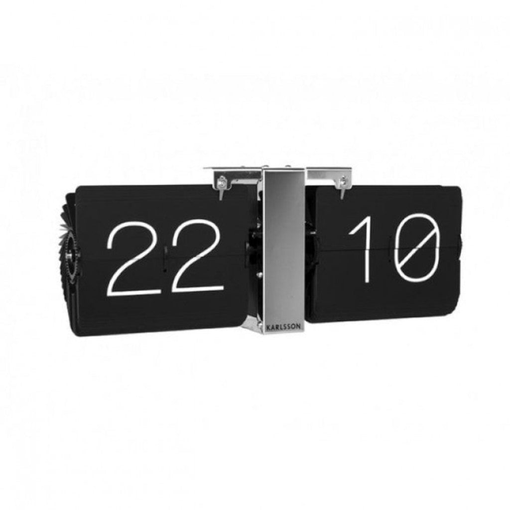 Flip clock with black face and white numbers on a white background