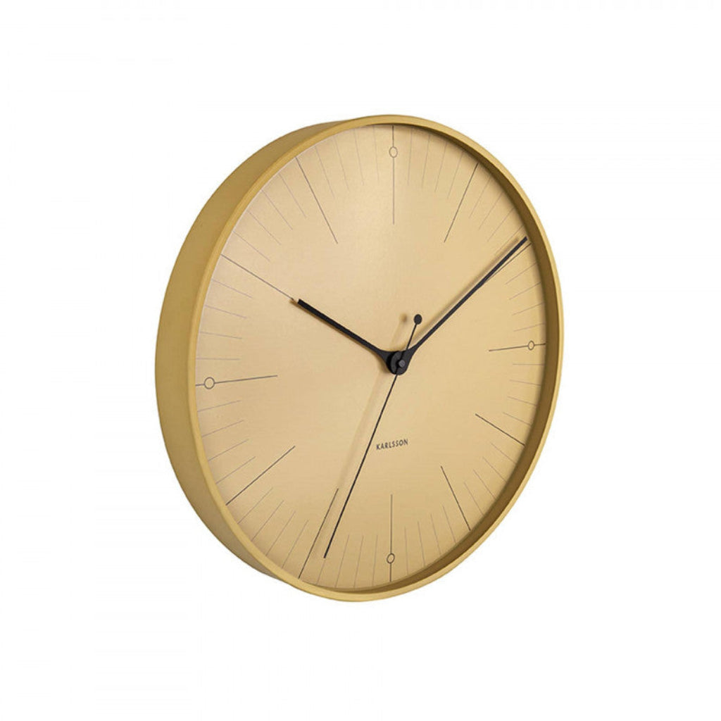 Gold wall clock with black hands on a white background