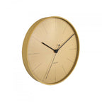Gold wall clock with black hands on a white background