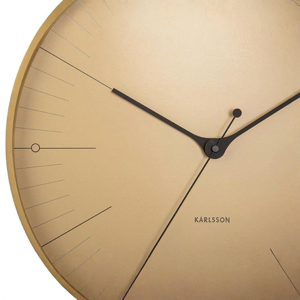 Beige wall clock with black hands and 'KARLSSON' branding on a beige background
