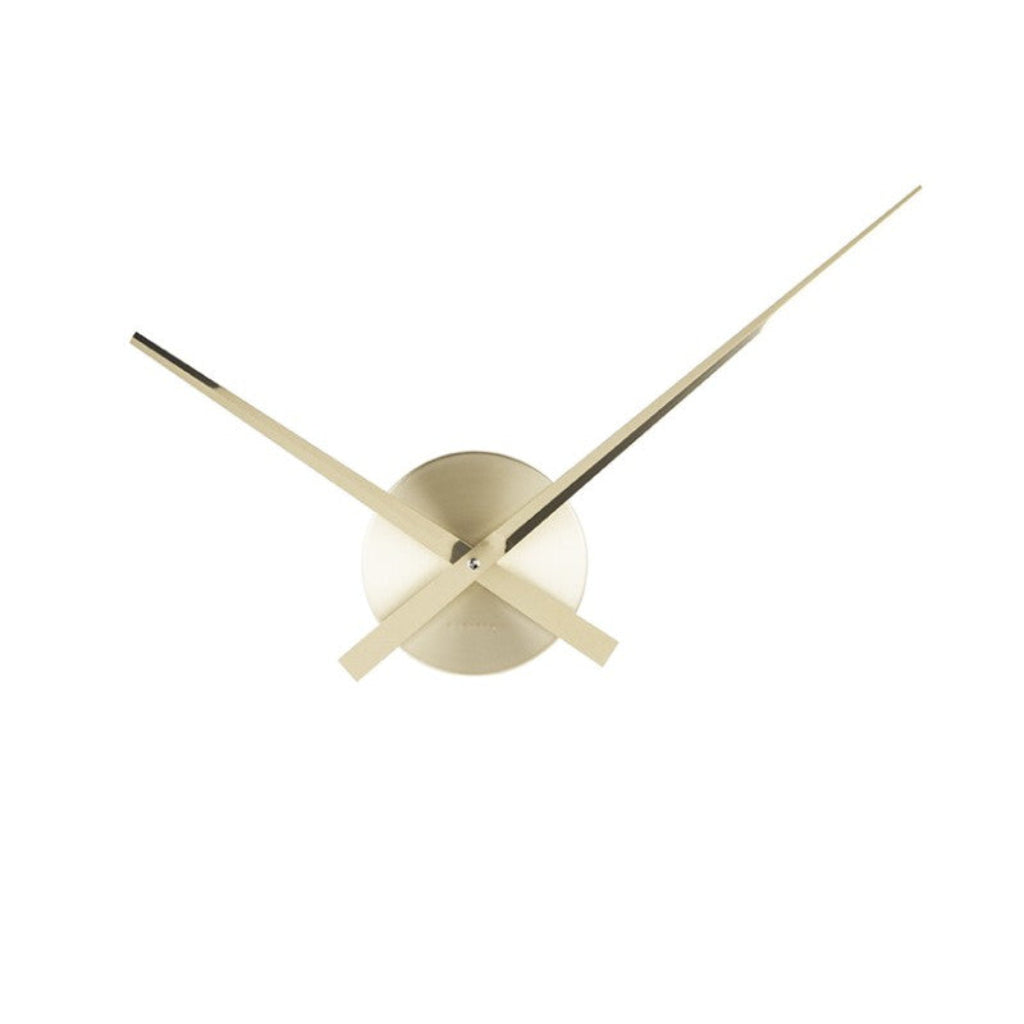 Gold wall clock with long thin hands on a white background from Karlsson available at Spacio retail stores in Mumbaii & Kolkata and online.