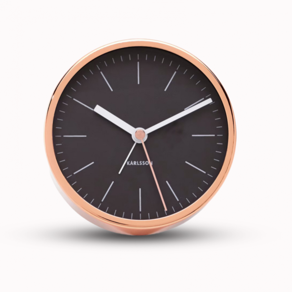 Round clock with black face and rose gold frame on a white background from Karlsson available at Spacio retail stores in Mumbaii & Kolkata and online.