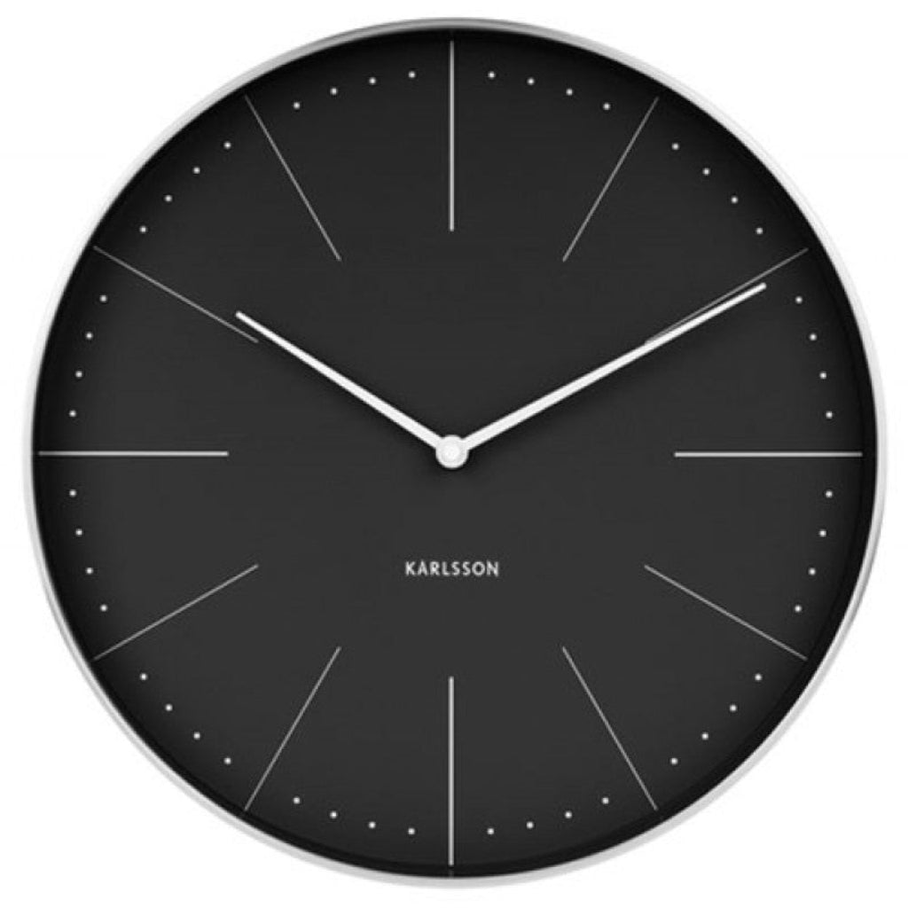 Black wall clock with white hands and 'KARLSSON' branding on a white background from karlsson available at Spacio retail stores in Mumbaii & Kolkata and online.