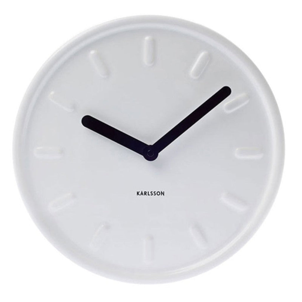 White wall clock with black hands and 'KARLSSON' branding on a white background from Karlsson available at Spacio retail stores in Mumbaii & Kolkata and online.