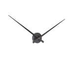 Black wall clock with long thin hands on a white background