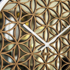 Wall clock with geometric wooden design and white hands on a black background