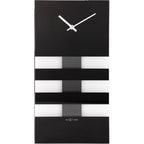 Black and white striped wall clock with 'NeXtime' branding on a white background available at Spacio retail stores in Mumbaii & Kolkata and online.