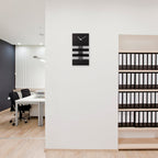 Modern office interior with a wall clock and file shelves.