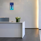 Modern office reception area with a white desk and decorative elements.