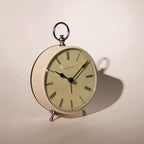 Vintage-style clock with Roman numerals on a plain background