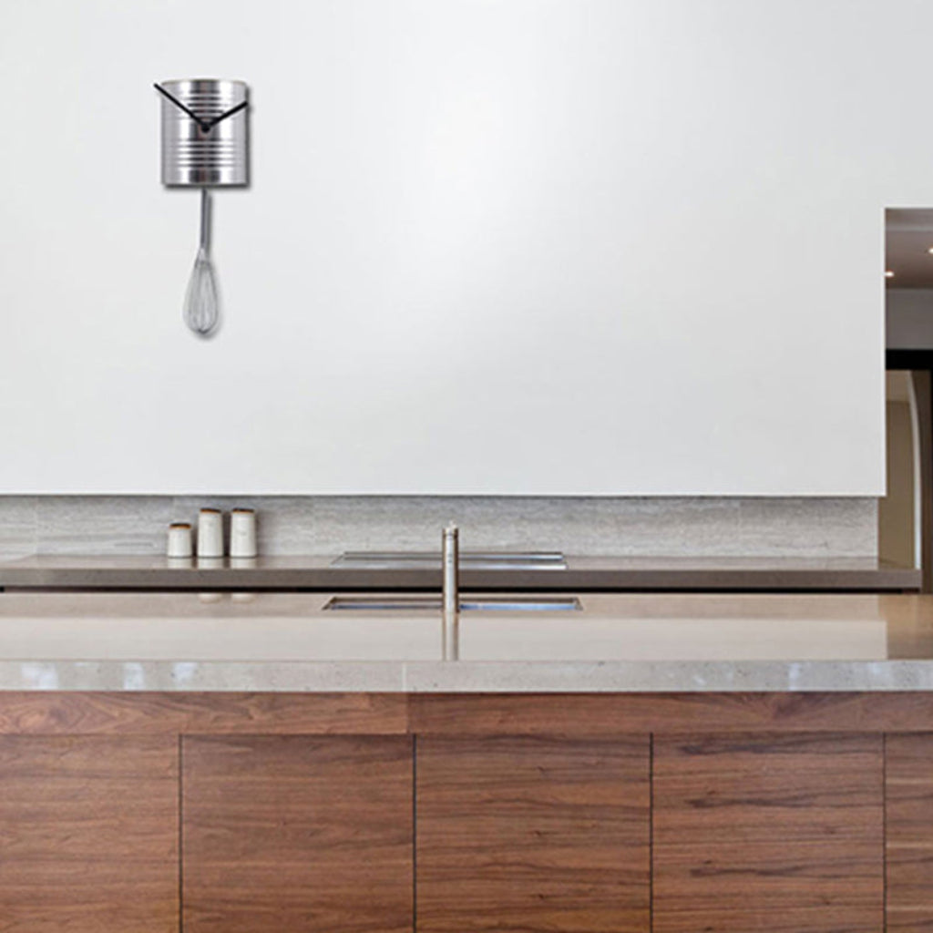 Modern kitchen with wooden cabinets, marble countertop, and wall-mounted clock.