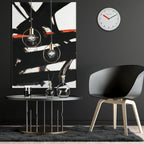 Modern interior with abstract painting, round table, and chair against a black wall.