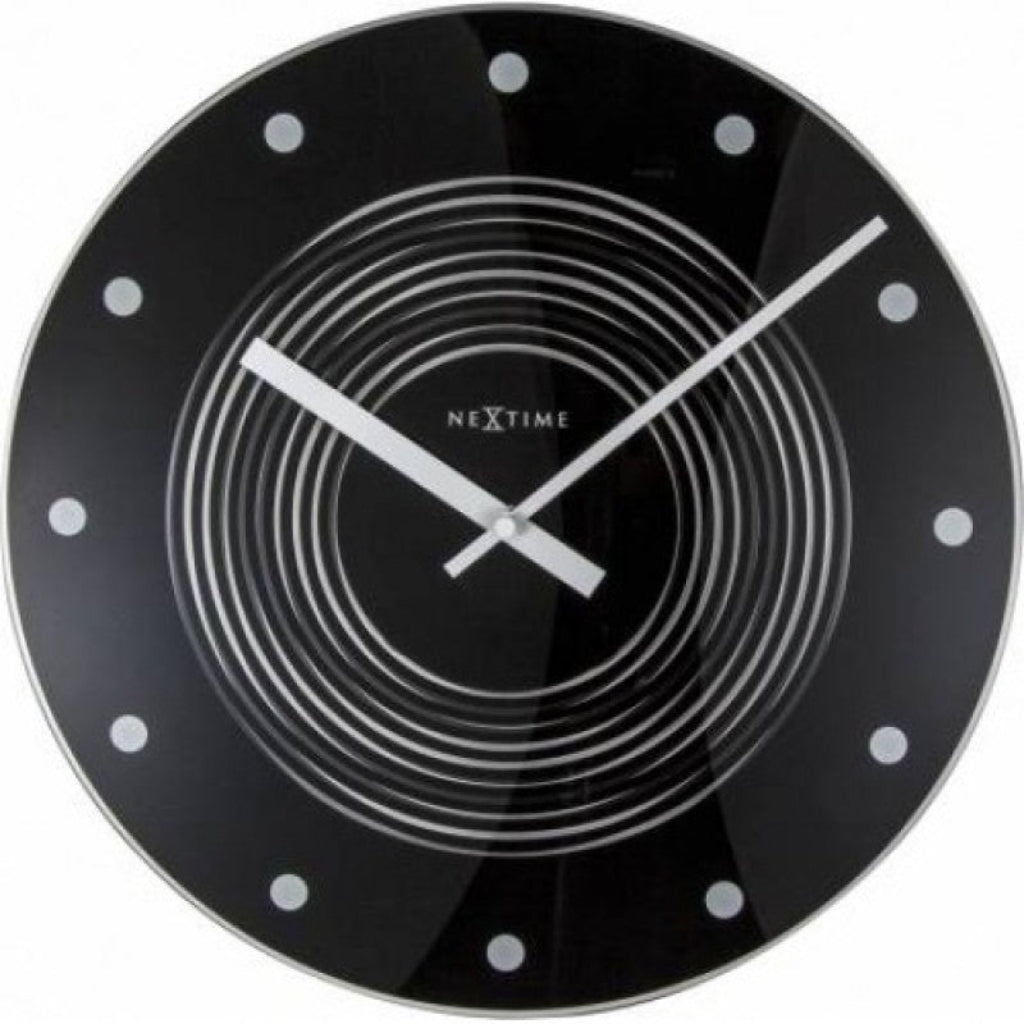 Black wall clock with white hands and 'NexTime' branding on a white background from Nextime available at Spacio retail stores in Mumbaii & Kolkata and online.