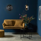 Modern living room with a mustard yellow sofa, dark blue walls, and decorative elements.