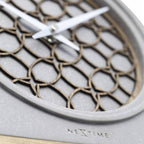 Close-up of a decorative wall clock with geometric design and 'Nextime' branding.
