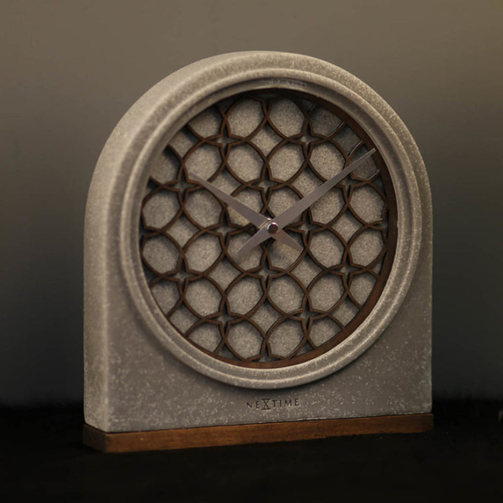Decorative clock with honeycomb design on a dark background