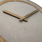 Close-up of a clock with wooden hands and 'Nextime' branding on a light gray background.