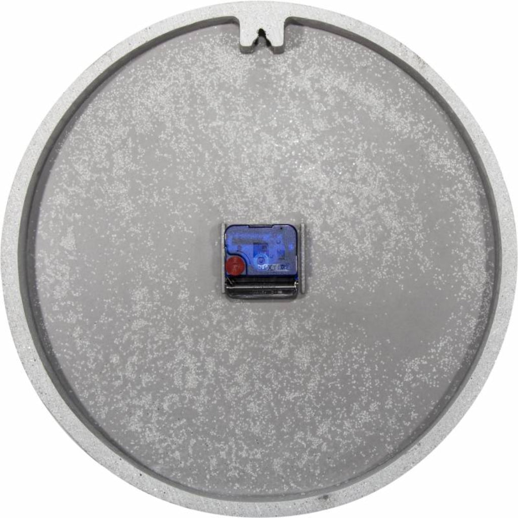 Round metallic object with a small electronic component on a white background