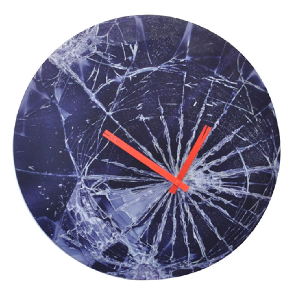 Broken glass clock with red hands on a white background from Nextime available at Spacio retail stores in Mumbaii & Kolkata and online.