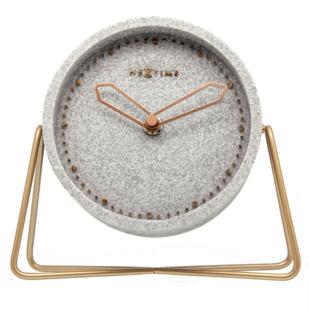 Table clock with gray textured face and gold metal stand on a white background