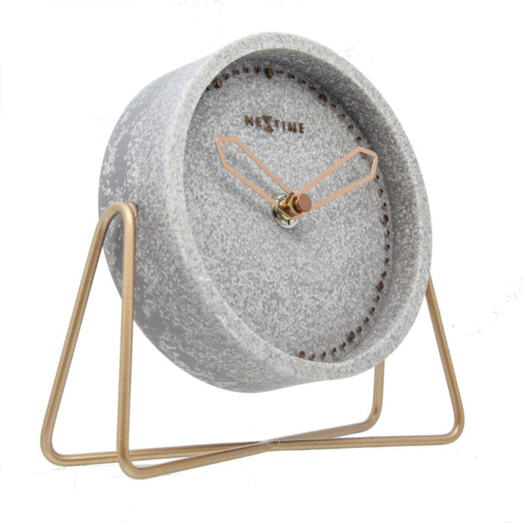 Gray clock with gold stand on a white background