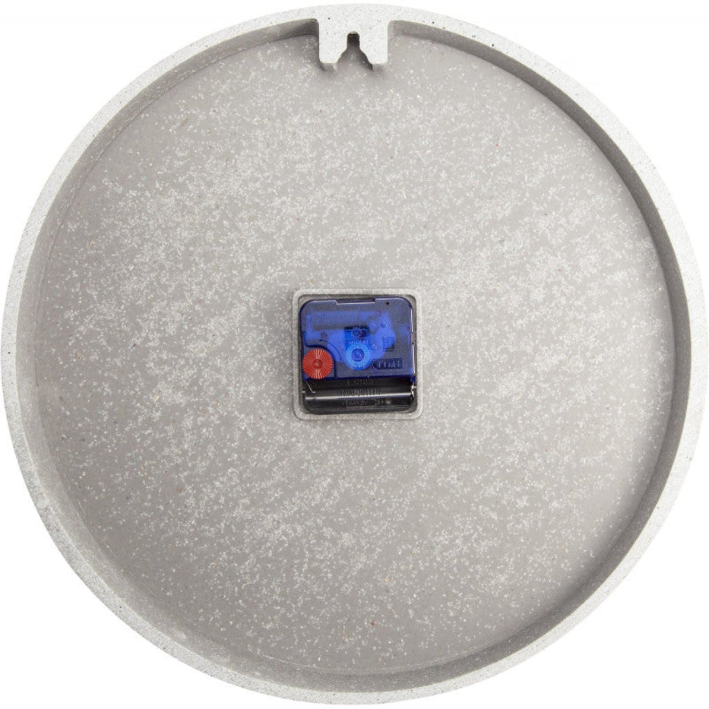 Round metallic object with a small electronic component on a white background
