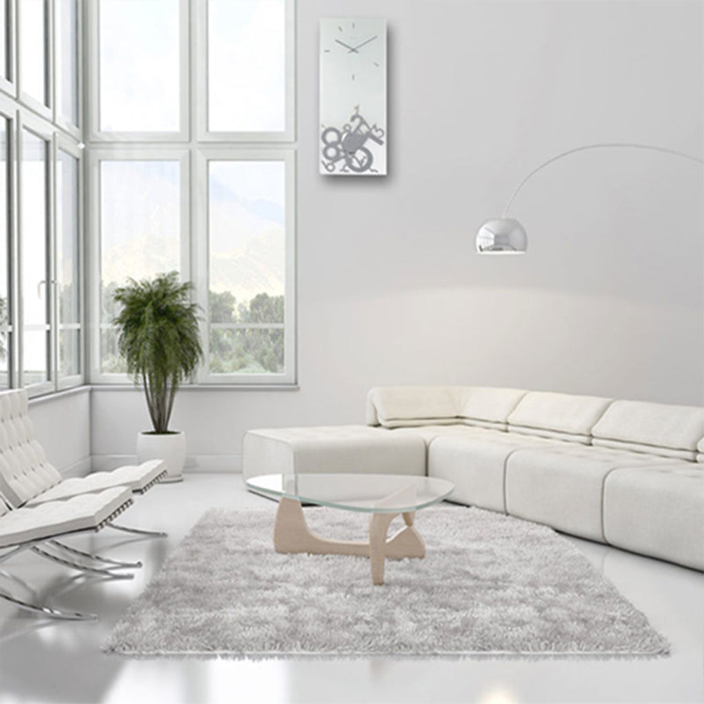 Modern living room with white furniture and a gray rug.