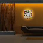 Modern wall clock with abstract design on a wall in a dimly lit room.