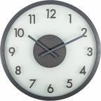 Round wall clock with black frame and white face on a white background from Nextime available at Spacio retail stores in Mumbaii & Kolkata and online.