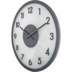 Wall clock with black frame and white face on a white background