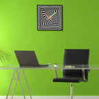 Modern office setup with a glass desk, black chair, and abstract art on a green wall.