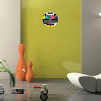 Modern living room with a colorful wall decal, orange vases, and a white sofa.