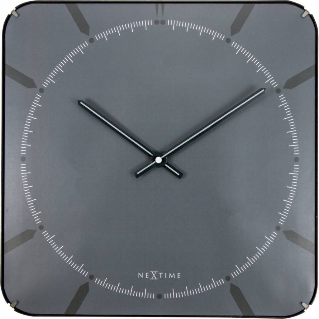 NeXtime wall clock with black frame and silver hands on a dark gray background from Nextime available at Spacio retail stores in Mumbaii & Kolkata and online.