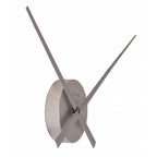 Silver wall clock with long thin hands on a white background